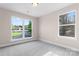 Bedroom with two windows providing natural light and a peaceful neighborhood view at 4219 Brownwood Nw Ln, Concord, NC 28027