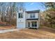 Charming two-story white home featuring a garage and a well-manicured lawn at 4219 Brownwood Nw Ln, Concord, NC 28027