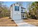 Charming two-story white home featuring a garage, covered front porch and well-manicured landscaping at 4219 Brownwood Nw Ln, Concord, NC 28027