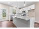Bright, open kitchen featuring modern appliances, granite countertops, an island and light colored cabinets at 4219 Brownwood Nw Ln, Concord, NC 28027