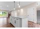 Bright, open kitchen featuring granite countertops, an island with dark hardware, and light colored cabinets at 4219 Brownwood Nw Ln, Concord, NC 28027
