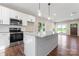 Modern kitchen with stainless steel appliances, granite countertops, and a bright, open space at 4219 Brownwood Nw Ln, Concord, NC 28027