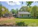 Home backyard with a trampoline, shed, grass, and a treed area at 4445 Pioneer Dr, Hickory, NC 28601