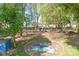 Backyard view of outdoor seating amidst mature trees at 4445 Pioneer Dr, Hickory, NC 28601