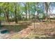 Backyard view of a patio with outdoor seating amidst mature trees at 4445 Pioneer Dr, Hickory, NC 28601