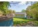 Home backyard features a large yard, an outbuilding, trampoline, and mature trees at 4445 Pioneer Dr, Hickory, NC 28601