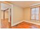 Cozy bedroom with hardwood floors, neutral walls, and bright natural light coming through curtained windows at 4445 Pioneer Dr, Hickory, NC 28601