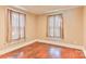Cozy bedroom with original hardwood floors and natural light streaming through curtained windows at 4445 Pioneer Dr, Hickory, NC 28601