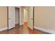 Bedroom displaying open closet and doorway with hardwood flooring at 4445 Pioneer Dr, Hickory, NC 28601