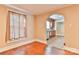 Bright living room featuring hardwood floors, large window with curtains, and arched entryway leading to the kitchen at 4445 Pioneer Dr, Hickory, NC 28601