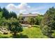 Home exterior with a backyard, pool, patio, raised garden beds, and abundant landscaping at 4607 Crewe Hall Ln, Waxhaw, NC 28173