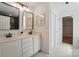Bathroom with double sinks, framed mirrors, white marble floors and adjacent walk-in closet at 4607 Crewe Hall Ln, Waxhaw, NC 28173