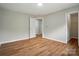 Light filled bedroom with wood look floors and neutral walls at 4607 Crewe Hall Ln, Waxhaw, NC 28173