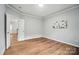 Spacious bedroom with neutral tones and a view into the next room, offers a flexible and inviting living space at 4607 Crewe Hall Ln, Waxhaw, NC 28173
