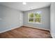 Bedroom offers wood-look flooring, neutral walls, closet and a sunny window at 4607 Crewe Hall Ln, Waxhaw, NC 28173