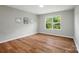 Bedroom features wood-look floors, neutral walls and large window for ample natural light at 4607 Crewe Hall Ln, Waxhaw, NC 28173