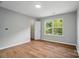 Bright bedroom features wood-look floors, neutral walls, large window and walk-in closet at 4607 Crewe Hall Ln, Waxhaw, NC 28173