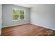 Bedroom boasts durable floors, neutral walls, and large window with outdoor views at 4607 Crewe Hall Ln, Waxhaw, NC 28173