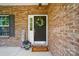 A welcoming front door with a wreath, flowers, and a welcome mat, adding curb appeal to this lovely home at 4607 Crewe Hall Ln, Waxhaw, NC 28173