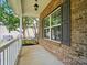 Inviting front porch with brick accents and a large window at 4607 Crewe Hall Ln, Waxhaw, NC 28173