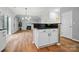 Open-concept kitchen boasts an island, granite countertops, and seamless flow into the living area with a cozy fireplace at 4607 Crewe Hall Ln, Waxhaw, NC 28173