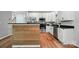 The stunning kitchen showcases stainless steel appliances, granite countertops, and a wood-paneled bar for a modern touch at 4607 Crewe Hall Ln, Waxhaw, NC 28173