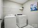 Functional laundry room features modern washer and dryer, along with shelving at 4607 Crewe Hall Ln, Waxhaw, NC 28173