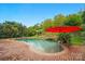 Outdoor pool with brick surround, lush landscaping and mature trees create a private backyard oasis at 4607 Crewe Hall Ln, Waxhaw, NC 28173
