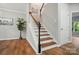 The staircase features wood steps, white risers, and leads to the upper level at 4607 Crewe Hall Ln, Waxhaw, NC 28173