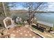 Secluded backyard with mature trees, sheds, a dock, and scenic lake views, offering a private and relaxing retreat at 466 Shoreline Rd, New London, NC 28127