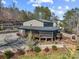 Spacious home with a large deck, well-maintained landscaping, and mature trees at 466 Shoreline Rd, New London, NC 28127