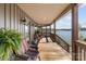 Inviting covered porch with comfortable seating and scenic lake views, perfect for relaxing and enjoying the outdoors at 466 Shoreline Rd, New London, NC 28127