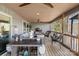 Relaxing screened porch with comfortable seating, a ceiling fan, and views of the surrounding trees and sky at 466 Shoreline Rd, New London, NC 28127