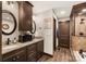 Bathroom featuring double sinks, granite counters, wooden cabinets, and a separate shower at 466 Shoreline Rd, New London, NC 28127