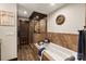 Luxurious bathroom with a deep soaking tub, glass-enclosed shower, and warm, earth-toned tile work at 466 Shoreline Rd, New London, NC 28127