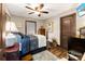 Comfortable bedroom featuring wood floors, a ceiling fan, and a vintage-style decor at 466 Shoreline Rd, New London, NC 28127