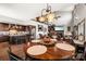 Open-concept dining area with modern lighting fixtures and seamless flow into the living room and kitchen at 466 Shoreline Rd, New London, NC 28127