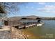 Scenic waterfront retreat featuring a private boat dock with boat and jet ski lifts, offering stunning lake access at 466 Shoreline Rd, New London, NC 28127