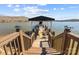 Picturesque waterfront property featuring a private boat dock with a covered seating area and lake access at 466 Shoreline Rd, New London, NC 28127