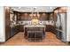 Spacious kitchen with dark wood cabinets, granite countertops, stainless steel appliances, and a center island with seating at 466 Shoreline Rd, New London, NC 28127