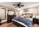Comfortable main bedroom featuring a ceiling fan, dark wood furniture, and cozy decorative pillows at 466 Shoreline Rd, New London, NC 28127
