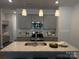 Stylish kitchen with gray cabinetry, stainless steel appliances, and a granite island with sink at 4724 Lakeview Rd # 26, Charlotte, NC 28216