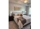Relaxing bedroom with a tray ceiling, a cozy bed, and decorative wall art above the headboard at 4724 Lakeview Rd # 26, Charlotte, NC 28216