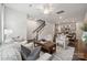 Comfortable living room showing open concept to kitchen and dining area, with stairway access at 4754 Lakeview N Rd # 19, Charlotte, NC 28216