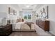 Bright main bedroom featuring a trey ceiling, neutral decor, and a large window at 4754 Lakeview N Rd # 19, Charlotte, NC 28216