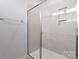 Modern tiled shower with glass enclosure, built in niche, and modern hardware at 4754 Lakeview N Rd # 19, Charlotte, NC 28216
