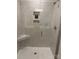 Stylish shower with glass door, tiled walls, and built-in shelving at 5103 Orchardview Way # 27, Charlotte, NC 28216