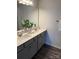 Bathroom with double sink vanity, quartz countertops, modern fixtures, and wood-look flooring at 5111 Orchardview Way # 25, Charlotte, NC 28216