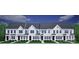 New construction townhomes featuring white siding, black doors, and perfectly manicured landscaping at 5111 Orchardview Way # 25, Charlotte, NC 28216