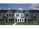 Newly constructed townhomes with well manicured lawn, dark roof and black doors at 5111 Orchardview Way # 25, Charlotte, NC 28216